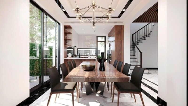 Để tạo nên vẻ đẹp tổng thể trong ý tưởng thiết kế không gian phòng ăn biệt thự Vinhomes Imperia Hải Phòng, việc sử dụng và trang trí vật liệu lát nền lại càng được chú ý. Sử dụng chút nghệ thuật sắp đặt như trong ý tưởng bố trí trên đây, đá lát nền phòng ăn được bao bọc xung quanh bởi khung viền đá đen như thể hiện ranh giới rõ ràng của phòng ăn, ngước lên trên, bạn có thể thấy vẻ đẹp này được thể hiện đồng điệu khi trần thạch cao được trang trí thêm đường viền vuông vắn phối cùng đèn âm tường tạo vẻ đẹp độc đáo cho không gian bếp.